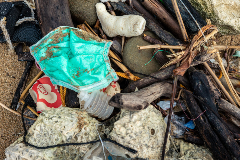 Rubbish from used medical masks washed up on the beach after a storm